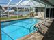 Sparkling pool with screened enclosure and waterfront views, perfect for relaxation and entertainment at 212 Poinciana Ln, Largo, FL 33770