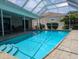 Relax in this inviting screened-in pool, perfect for enjoying sunny days in comfort and style at 212 Poinciana Ln, Largo, FL 33770