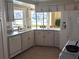 Well-equipped kitchen with white cabinets and water views at 212 Poinciana Ln, Largo, FL 33770