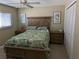 Guest bedroom with a queen-size bed and wood furniture at 212 Poinciana Ln, Largo, FL 33770
