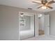 Bright bedroom with mirrored closet doors and ceiling fan at 2579 Madrid S Way, St Petersburg, FL 33712