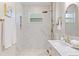 Spa-like bathroom with marble tile, a walk-in shower, and a double vanity at 3811 N Arlington Ave, Tampa, FL 33603