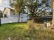 Backyard with grass, trees, and AC unit at 5018 Chancellor Ne St, St Petersburg, FL 33703