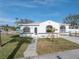 Newly renovated home with a white exterior and landscaped yard at 7951 Gulf Blvd, St Pete Beach, FL 33706