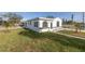 Newly renovated home with a large grassy yard and walkway at 7951 Gulf Blvd, St Pete Beach, FL 33706