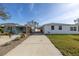 Newly renovated home with a long driveway and neighboring house at 7951 Gulf Blvd, St Pete Beach, FL 33706