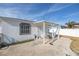 Backyard patio area with a covered patio and white fence at 7951 Gulf Blvd, St Pete Beach, FL 33706
