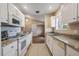 Kitchen with white cabinets and granite countertops at 9016 Shallowford Ln # 202, Port Richey, FL 34668
