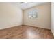 Well-lit bedroom with wood-look flooring and a window at 9016 Shallowford Ln # 202, Port Richey, FL 34668