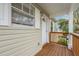 Condo front door entrance with a wooden deck and railing at 9016 Shallowford Ln # 202, Port Richey, FL 34668