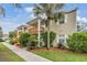 Tan two-story condo with balcony, landscaping, and walkway at 9016 Shallowford Ln # 202, Port Richey, FL 34668
