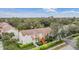 Aerial view of condos near a lake, showcasing landscaping and parking at 9016 Shallowford Ln # 202, Port Richey, FL 34668