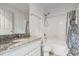 Bathroom with granite countertop, white vanity, and shower/tub at 9016 Shallowford Ln # 202, Port Richey, FL 34668