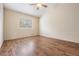 Bedroom with wood flooring and a ceiling fan at 9016 Shallowford Ln # 202, Port Richey, FL 34668