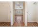 Hallway with wood flooring and access to bedrooms at 9016 Shallowford Ln # 202, Port Richey, FL 34668