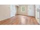 Dining room with wood-look flooring and access to kitchen at 9016 Shallowford Ln # 202, Port Richey, FL 34668