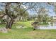 Community with pond, lush landscaping, and grilling area at 9016 Shallowford Ln # 202, Port Richey, FL 34668