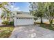 Attached garage with a paved driveway at 902 Woodbridge Ct, Safety Harbor, FL 34695