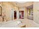 Luxurious bathroom with a large soaking tub and and vanities at 101 12Th E St, Tierra Verde, FL 33715