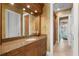 Bathroom with wood cabinets and access to bedroom at 101 12Th E St, Tierra Verde, FL 33715