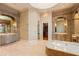 Spacious bathroom with dual vanities and a free-standing tub at 101 12Th E St, Tierra Verde, FL 33715