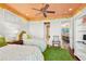 Charming bedroom with two twin beds, green rug, and painted ceiling at 101 12Th E St, Tierra Verde, FL 33715