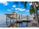 Boat lift and private dock with a beautiful waterfront view at 101 12Th E St, Tierra Verde, FL 33715