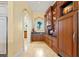 Butler's pantry with custom cabinetry, granite countertops, and wine storage at 101 12Th E St, Tierra Verde, FL 33715