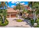 Two-story home with circular driveway and lush landscaping at 101 12Th E St, Tierra Verde, FL 33715