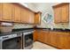 Bright laundry room with wood cabinets, granite counters, and modern washer/dryer at 101 12Th E St, Tierra Verde, FL 33715