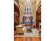 Elegant library featuring a vaulted ceiling, hardwood floors, and ample built-in shelving at 101 12Th E St, Tierra Verde, FL 33715