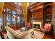 Elegant library with fireplace, built-in bookshelves, and stunning water views at 101 12Th E St, Tierra Verde, FL 33715