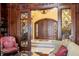 Elegant library with ornate wood details and access to entryway at 101 12Th E St, Tierra Verde, FL 33715