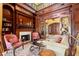 Library features a fireplace, built-in shelving, and French doors at 101 12Th E St, Tierra Verde, FL 33715
