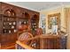 Elegant home office with built-in bookshelves and a custom desk at 101 12Th E St, Tierra Verde, FL 33715