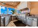 High-end outdoor kitchen with stainless steel appliances and granite counters at 101 12Th E St, Tierra Verde, FL 33715