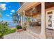 Covered outdoor kitchen with a built-in grill and bar seating at 101 12Th E St, Tierra Verde, FL 33715