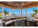 Outdoor kitchen with granite countertops and stainless steel appliances at 101 12Th E St, Tierra Verde, FL 33715
