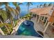 Elevated view of a kidney-shaped pool and spa at 101 12Th E St, Tierra Verde, FL 33715