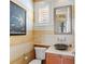 Stylish powder room with unique sink and decorative walls at 101 12Th E St, Tierra Verde, FL 33715