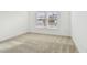 Bright bedroom with neutral carpeting and two large windows at 12620 Glenn Creek Dr, Riverview, FL 33569