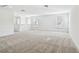 Bright and spacious bonus room with carpeted floor and two windows at 12620 Glenn Creek Dr, Riverview, FL 33569