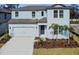 Two-story house with light blue siding, gray roof, and landscaping at 12620 Glenn Creek Dr, Riverview, FL 33569
