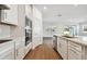 Modern kitchen with white cabinets, stainless steel appliances, and quartz countertops at 12620 Glenn Creek Dr, Riverview, FL 33569