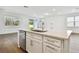 Modern kitchen island with quartz countertop and stainless steel sink at 12620 Glenn Creek Dr, Riverview, FL 33569