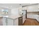 Island kitchen with white cabinets, stainless steel dishwasher, and quartz countertops at 12620 Glenn Creek Dr, Riverview, FL 33569