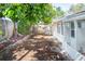 Side yard with mature trees and privacy fence at 1537 Excalibur St, Holiday, FL 34690