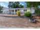 Landscaped yard with a charming house and driveway at 1537 Excalibur St, Holiday, FL 34690
