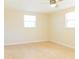 Simple bedroom with tile floors, ceiling fan, and two windows at 1537 Excalibur St, Holiday, FL 34690