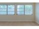 Spacious basement room featuring tile floors and three large windows at 1537 Excalibur St, Holiday, FL 34690